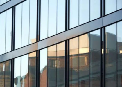 Stick vs Unitized Curtain Walls: A Comprehensive Guide for Modern Architecture in Pakistan Stick vs Unitized Curtain Walls shown on a modern glass building façade.