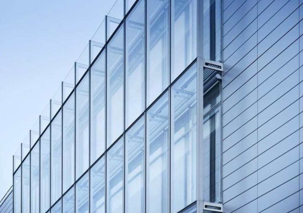 Stick vs Unitized Curtain Walls: A Comprehensive Guide for Modern Architecture in Pakistan Stick vs Unitized Curtain Walls displayed on a modern building facade.