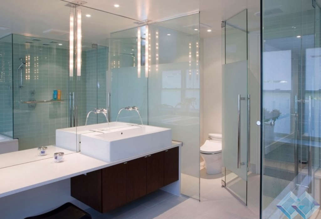 Elegant glass cabin in a small bathroom enhancing space and style.