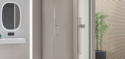 Modern glass cabin maximizing space in a compact bathroom.