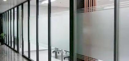 Sleek frameless soundproof glass partition creating quiet meeting pods in a modern Pakistani office