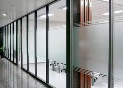 Sleek frameless soundproof glass partition creating quiet meeting pods in a modern Pakistani office