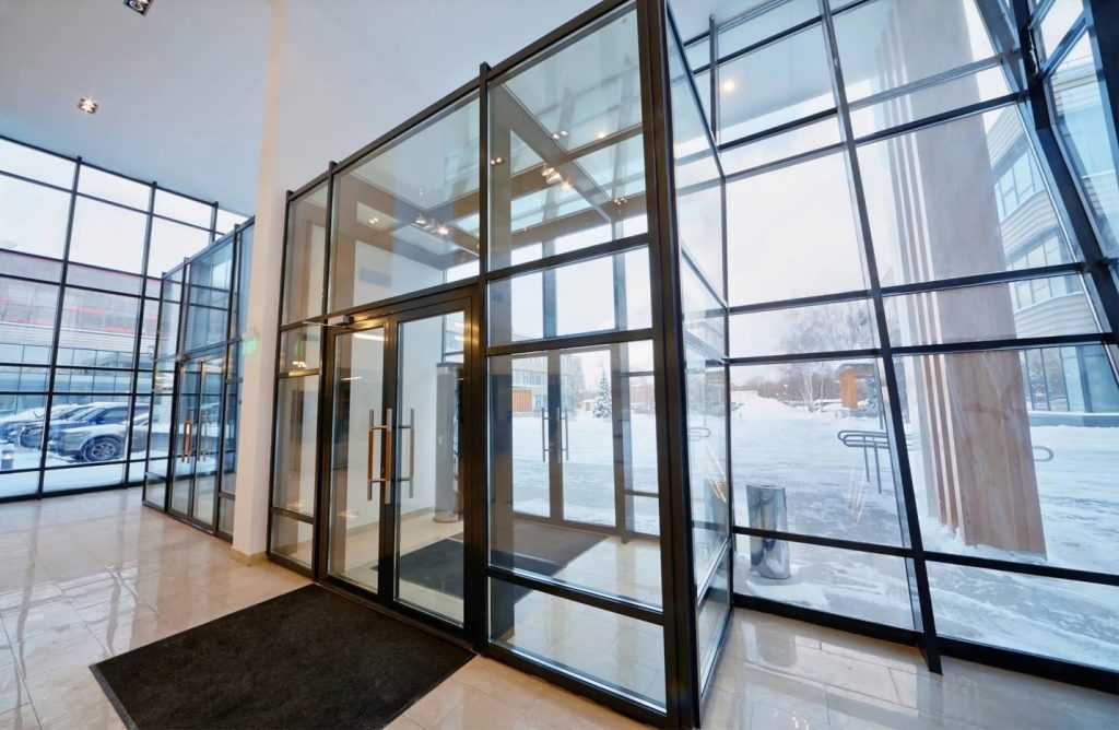 Frameless glass structure supported by point-fixed glass systems in contemporary architecture.