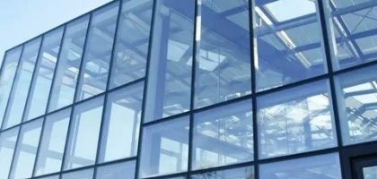 Frameless glass façade using point glass fixing systems in modern architectural design.